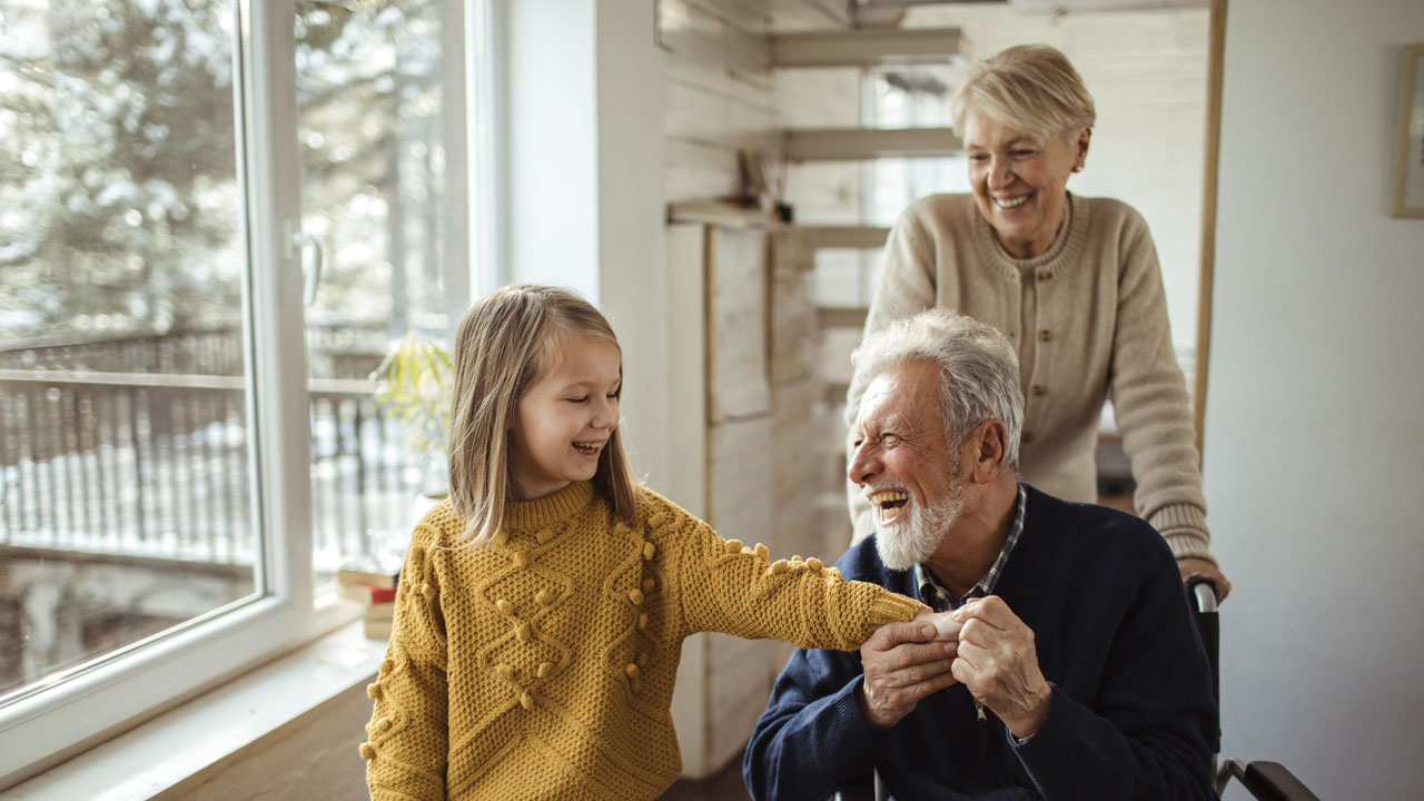 Grandparents playing with their granddaughter
