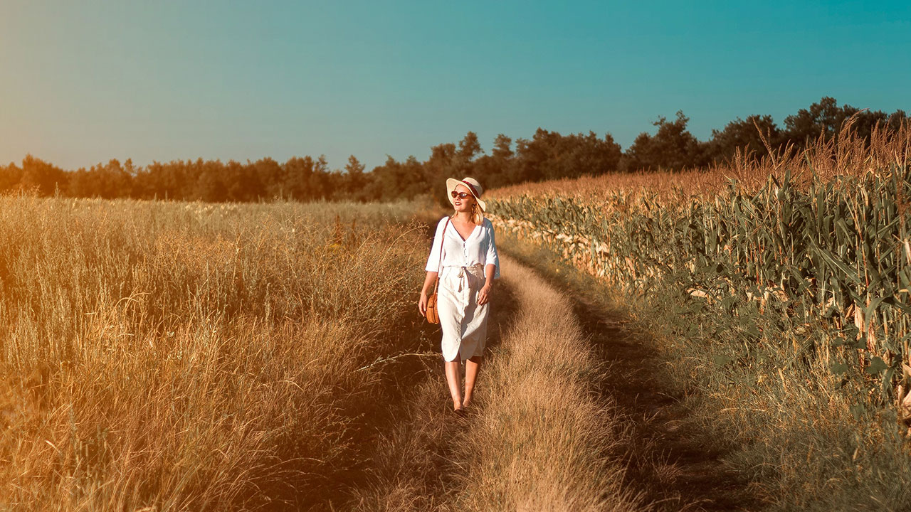 Woman walking on the grass field
